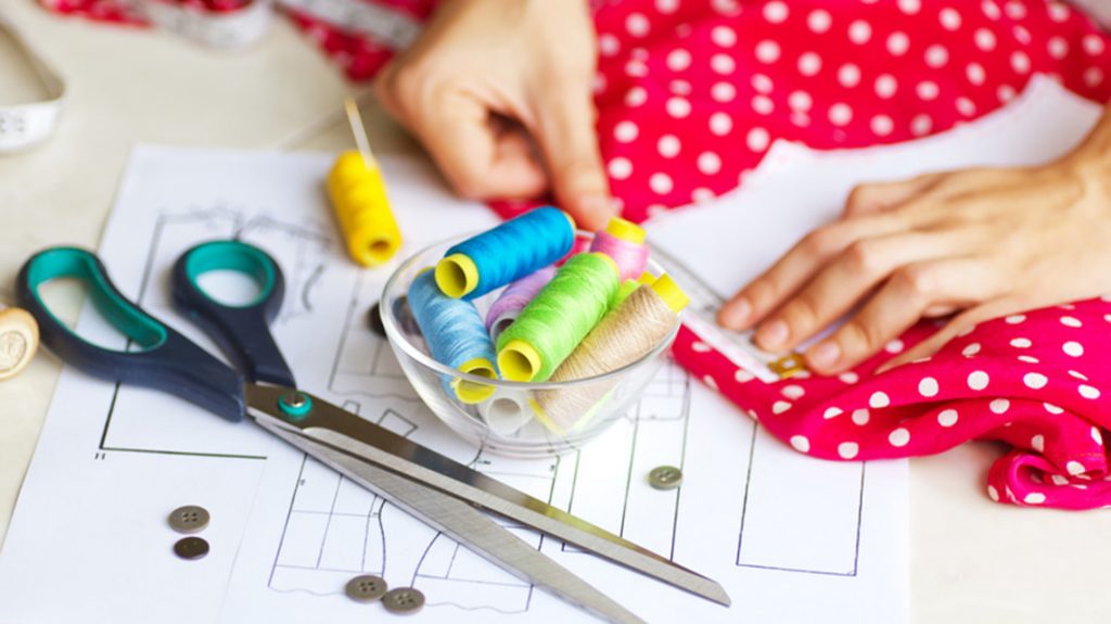 A tailor is laying out a dress/Sewing layout. Soft focus